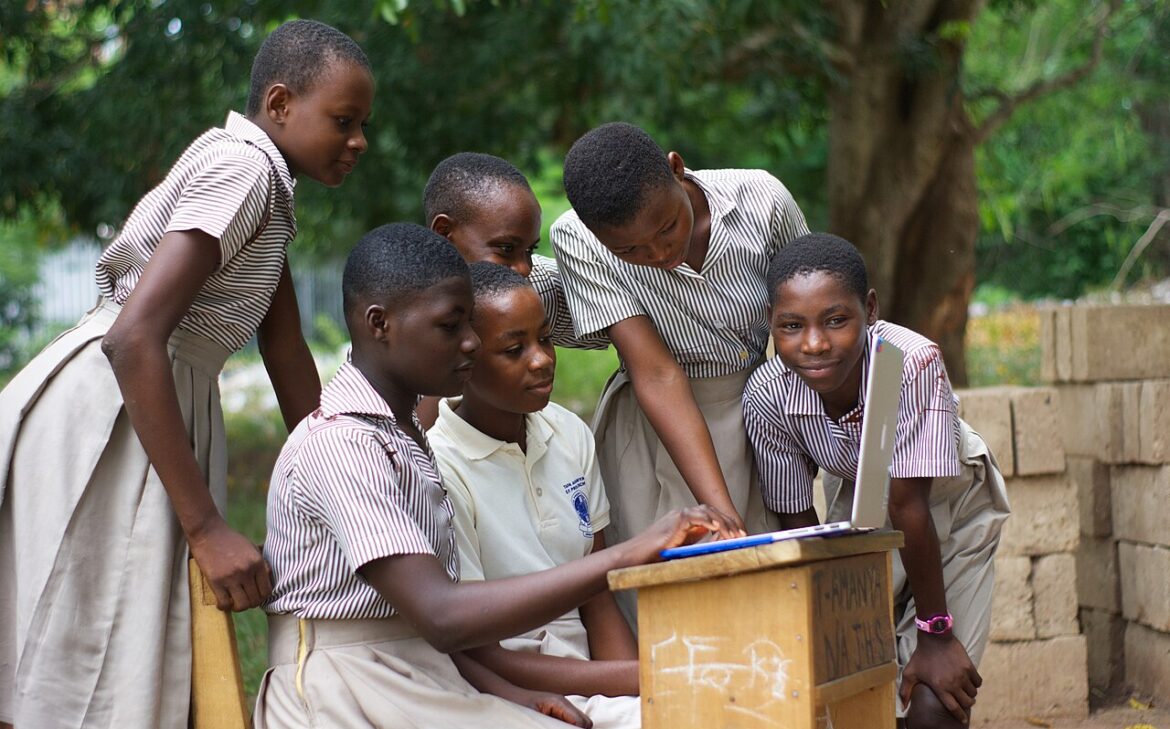 A group of students using a computer laptop.jpg