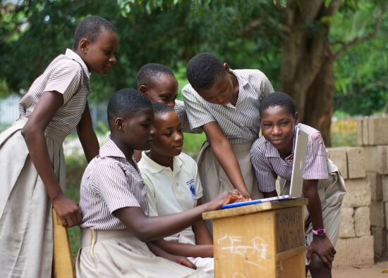 A group of students using a computer laptop.jpg